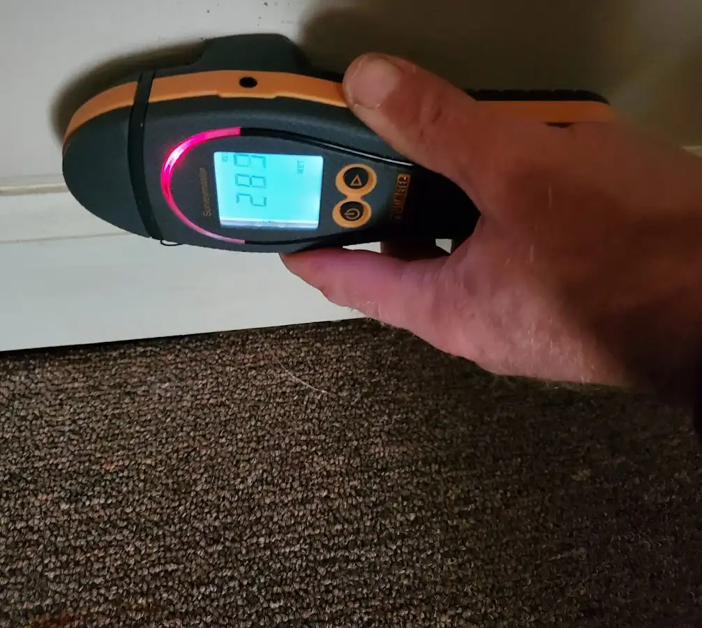 Moisture detection at baseboard during Storm Damage Restoration in Brook Park